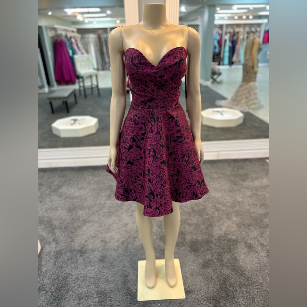 Size 14. Magenta and black color. Sweetheart neckline. Strapless. Skater skirt.